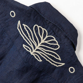 material shot of the back embroidered yoke on The Embroidered Short Sleeve Western in Indigo Linen, Wovens by Taylor Stitch