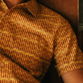 fit model showing the pattern detail on The Short Sleeve Hawthorne in Gold Wave, Wovens by Taylor Stitch