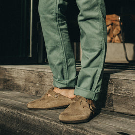 fit model standing on wooden steps in The Chore Pant in Ocean Boss Duck, Bottoms by Taylor Stitch