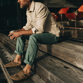 fit model sitting on wooden steps in The Chore Pant in Ocean Boss Duck, Bottoms by Taylor Stitch