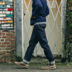 fit model walking in The Democratic Jean in Rinsed Organic Selvage, Bottoms by Taylor Stitch