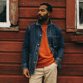 fit model wearing The Ojai Jacket in Sawyer Wash Selvage beside a barn, Outerwear by Taylor Stitch