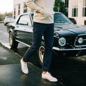 fit model walking in front of a car in The Slim Foundation Pant in Dark Navy, Bottoms by Taylor Stitch