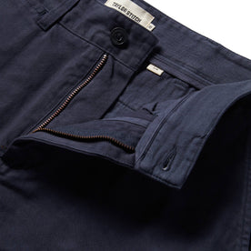 material shot of The Slim Foundation Pant in Dark Navy with an open fly, Bottoms by Taylor Stitch