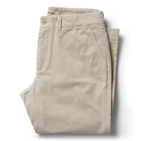 folded flatlay of The Slim Foundation Pant in Organic Stone, Bottoms by Taylor Stitch