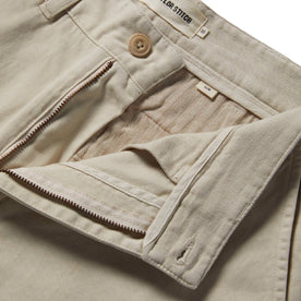 material shot with open zipper fly of The Slim Foundation Pant in Organic Stone, Bottoms by Taylor Stitch