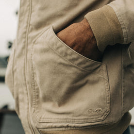 fit model with his hands in the pockets of The Workhorse Hoodie in Sand Boss Duck, Outerwear by Taylor Stitch