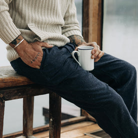 fit model sitting in The Apres Pant in Charcoal Donegal, Bottoms by Taylor Stitch