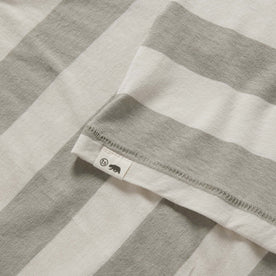 material shot of the TS label on The Cotton Hemp Tee in Natural and Sagebrush Stripe, Knits by Taylor Stitch