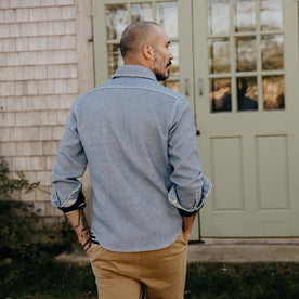 fit model sitting wearing The Division Shirt in Washed Indigo, Wovens by Taylor Stitch