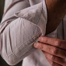 fit model buttoning the cuffs on The Jack in Antique Terracotta Micro Seersucker, Wovens by Taylor Stitch