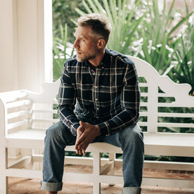 fit model sitting in The Jack in Midnight Plaid, Wovens by Taylor Stitch