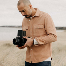 fit model posing in The Ledge Shirt in Dusty Coral Twill, Wovens by Taylor Stitch