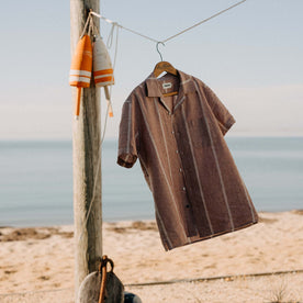 editorial image of The Short Sleeve Hawthorne in Dried Fig Stripe the beach, Wovens by Taylor Stitch