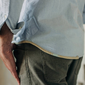 fit model wearing The Atelier and Repairs Jack in Washed Blue Oxford, bottom detail, Wovens by Taylor Stitch