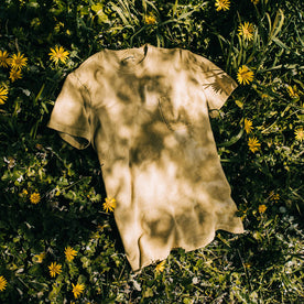 outdoor material shot of The Botanical Dye Tee in Ochre, sitting in bed of flowers, Knits by Taylor Stitch