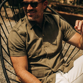 fit model wearing The Havana in in Olive Jacquard Stripe, sitting in chair, Wovens by Taylor Stitch