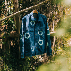 outdoor material shot of The Long Haul Jacket in Hand-Dyed Indigo, hanging on branch, Outerwear by Taylor Stitch