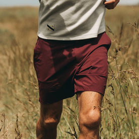 fit model wearing The Traverse Short in Wine, walking i field, Shorts by Taylor Stitch