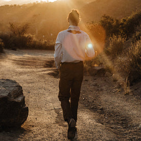 fit model walking on a sunny trail in The Embroidered Western Shirt in Washed Selvage, Wovens by Taylor Stitch