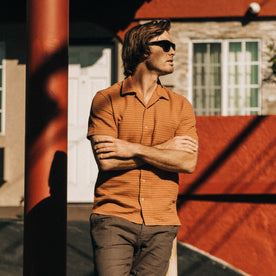 fit model standing in The Short Sleeve Hawthorne in Rust Pickstitch Waffle, Wovens by Taylor Stitch