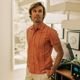 fit model posing by a turntable in The Short Sleeve Hawthorne in Rust Stripe , Wovens by Taylor Stitch