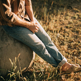 fit model sitting in The Slim Jean in Patch Wash Selvage, Bottoms by Taylor Stitch