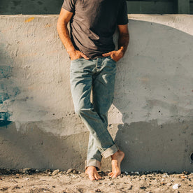 fit model wearing The Democratic Jean in 24-Month Japanese Selvage on beach, Bottoms by Taylor Stitch