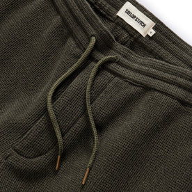 material shot of the drawcord and elasticated waist on The Apres Short in Army Waffle, Bottoms by Taylor Stitch