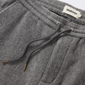 material shot of the drawcords and elasticated waist on The Apres Short in Charcoal Waffle, Bottoms by Taylor Stitch