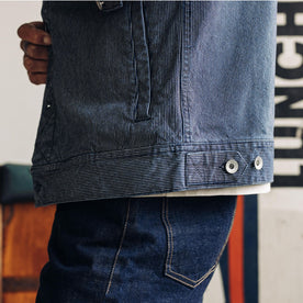 fit model showing the hem of The Long Haul Jacket in Washed Indigo Stripe, Outerwear by Taylor Stitch