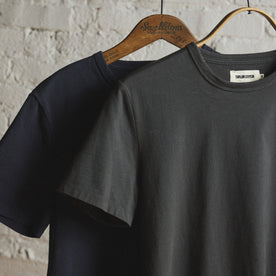 material shot of the sleeve on The Organic Cotton Tee in Faded Black, Knits by Taylor Stitch