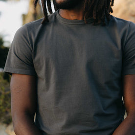 fit model posing in The Organic Cotton Tee in Faded Black, Knits by Taylor Stitch