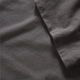 material shot of the sleeve on The Organic Cotton Tee in Faded Black, Knits by Taylor Stitch