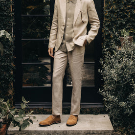 fit model standing by a doorway in The Sheffield Trouser in Natural Linen, Bottoms by Taylor Stitch