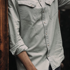 fit model wearing The Western Shirt in Bleached Indigo Stripe with rolled up sleeves, Wovens by Taylor Stitch