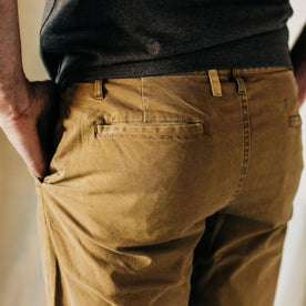 material shot of The Atelier and Repairs Chino in British Khaki, model wearing chinos—back detail, Bottoms by Taylor Stitch