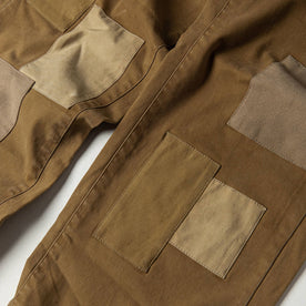 material shot of The Atelier and Repairs Chino in British Khaki, patches on front, Bottoms by Taylor Stitch