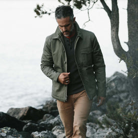 fit model wearing The Lined Watts Jacket in Olive in front of a lake, Outerwear by Taylor Stitch