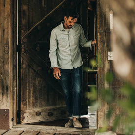 fit model wearing The Western Shirt in Washed Denim, walking through door, Wovens by Taylor Stitch