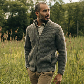 fit model walking through a field wearing The Fisherman Full-Zip in Taupe, Knits by Taylor Stitch