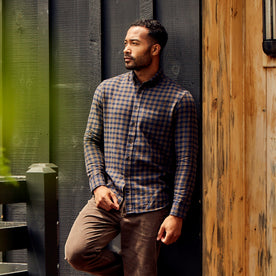 fit model leaning against a wall in The Jack in Terrace Plaid, Wovens by Taylor Stitch