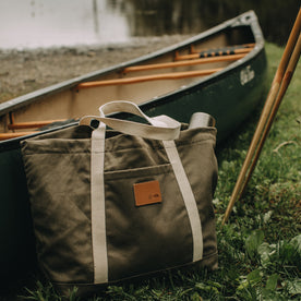 flatlay of The Market Tote in Stone Boss Duck by a lake, Accessories by Taylor Stitch