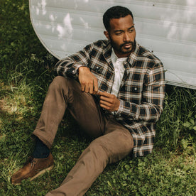 fit model sitting in The Ledge Shirt in Admiral Plaid, Wovens by Taylor Stitch