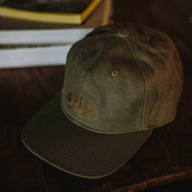 material shot of The Ball Cap in Stone Boss Duck on a table, Accessories by Taylor Stitch