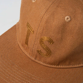 material shot of The Ball Cap in Tobacco Boss Duck showing TS, Accessories by Taylor Stitch