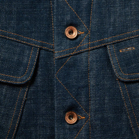 material shot of The Lined Long Haul Jacket in Green Cast Denim showing placket and buttons, Outerwear by Taylor Stitch