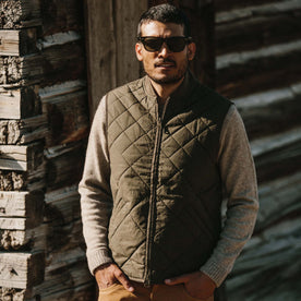 Fit model wearing The Quilted Bomber Vest in Olive Dry Wax with hands in pocket, Outerwear by Taylor Stitch