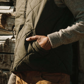 Fit model wearing The Quilted Bomber Vest in Olive Dry Wax with close up of quilted texture, Outerwear by Taylor Stitch