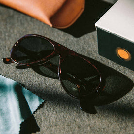 material shot of The Surf Aviator in Dark Tortoise next to box, Accessories by Taylor Stitch